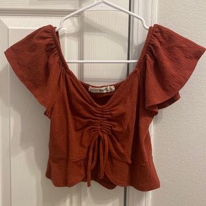 Marshall’s Live To Be Spoiled burnt orange frilly cropped top